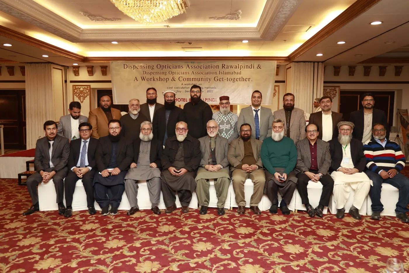 Wide group photograph of the full Dispensing Opticians Association gathering at PC Hotel Rawalpindi