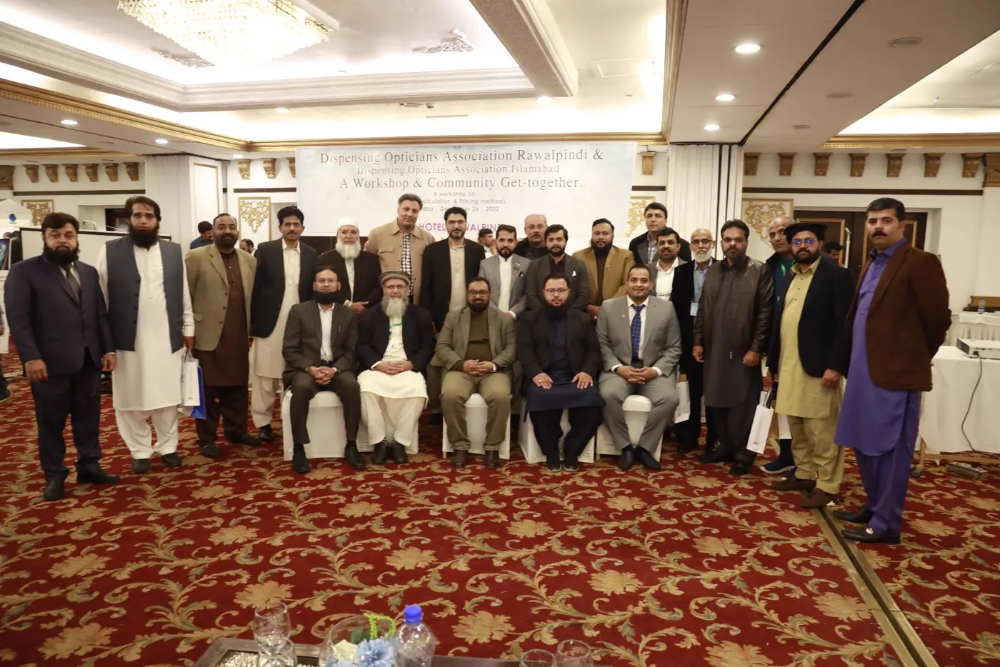 Group photograph of Dispensing Opticians Association Rawalpindi and Islamabad members under the workshop banner