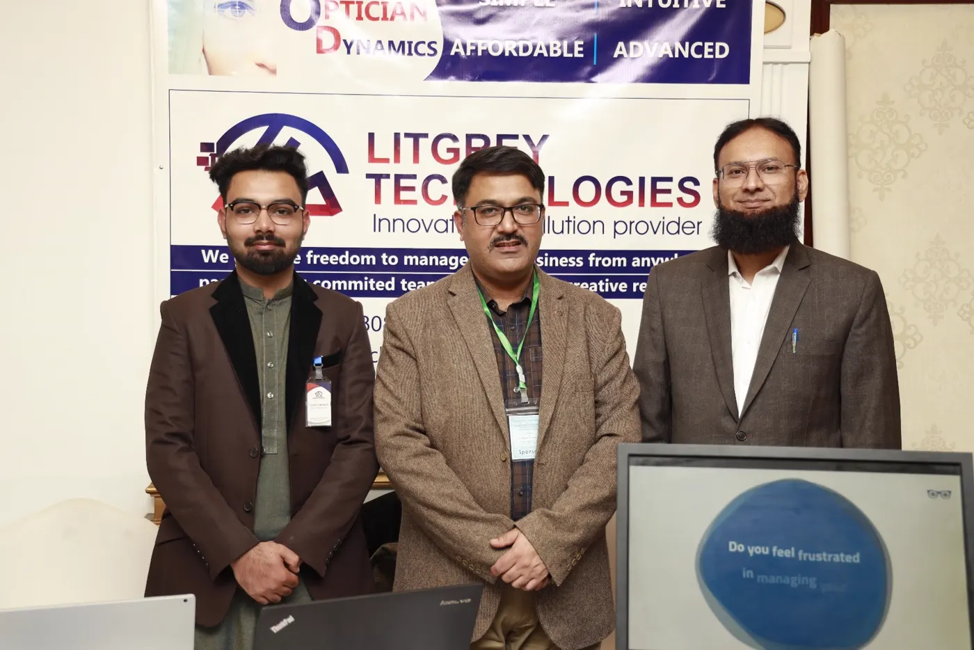 The LitGrey Technologies team at the Optician Dynamics exhibition booth under the Simple, Intuitive, Affordable, Advanced banner